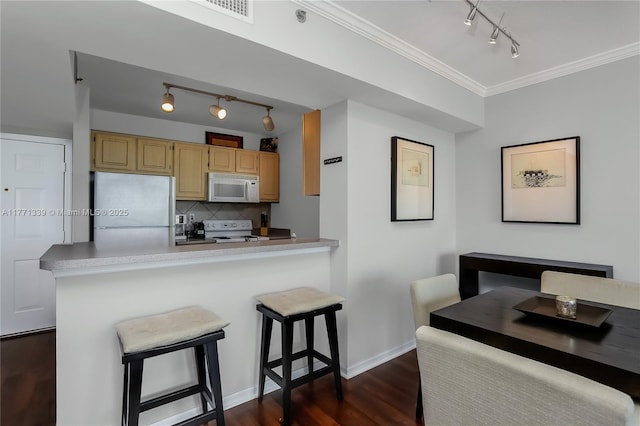 2665 SW 37th Ave Unit 1404, Miami, FL 33133 - kitchen featuring white appliances, rail lighting, dark wood finished floors, light countertops, and light brown cabinetry