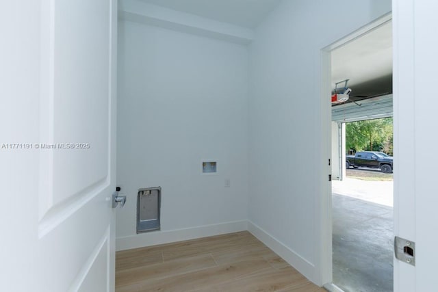 washroom featuring hookup for a washing machine, light wood finished floors, baseboards, ceiling fan, and laundry area