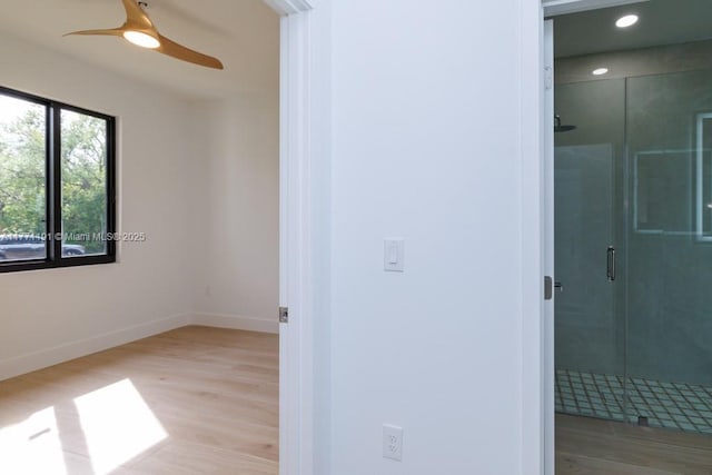 interior space with baseboards, wood finished floors, recessed lighting, and a ceiling fan