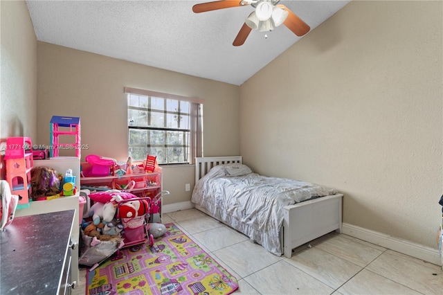 tiled bedroom with baseboards, lofted ceiling, a textured ceiling, and a ceiling fan