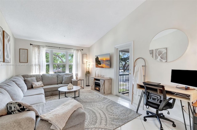 2307 N Congress Ave Unit 28, Boynton Beach, FL 33426 - living area featuring lofted ceiling, an office area, healthy amount of natural light, and light tile patterned floors
