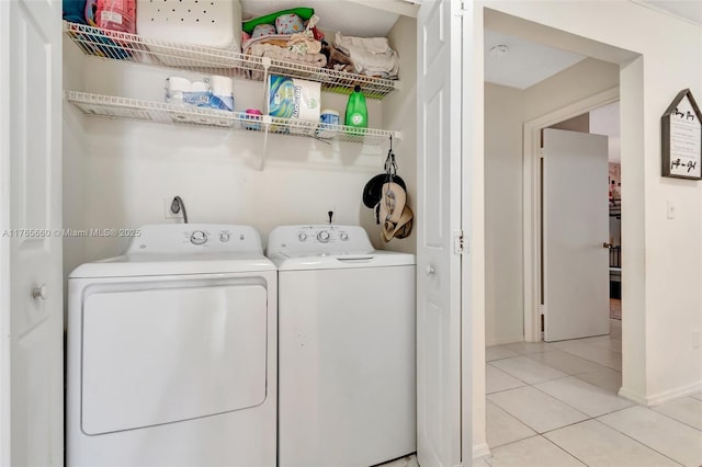 2307 N Congress Ave Unit 28, Boynton Beach, FL 33426 - clothes washing area featuring washer and dryer, light tile patterned floors, and baseboards