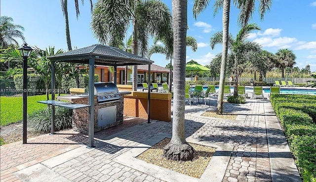 2307 N Congress Ave Unit 28, Boynton Beach, FL 33426 - view of jungle gym with fence, a community pool, a gazebo, and a patio
