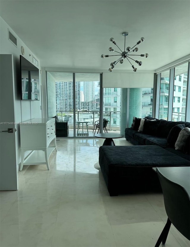 living room with a wall of windows, visible vents, and a chandelier