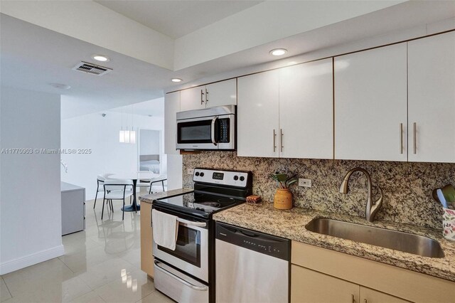 20515 E Country Club Dr Unit 1641, Aventura, FL 33180 - kitchen featuring a sink, backsplash, light stone countertops, appliances with stainless steel finishes, and visible vents