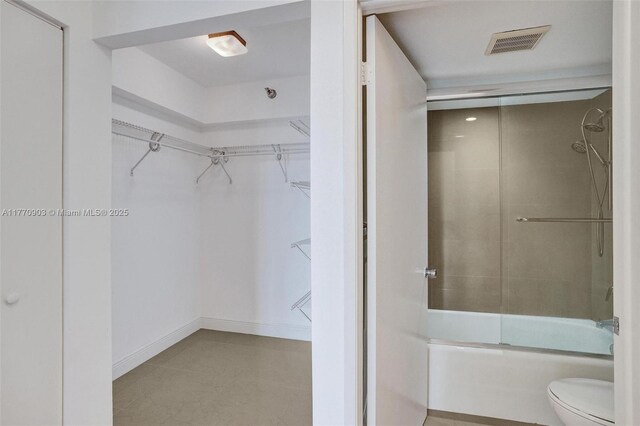20515 E Country Club Dr Unit 1641, Aventura, FL 33180 - full bath with toilet, combined bath / shower with glass door, a walk in closet, and visible vents