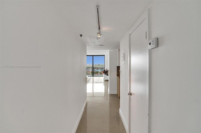 20515 E Country Club Dr Unit 1641, Aventura, FL 33180 - corridor with baseboards, track lighting, and light tile patterned floors