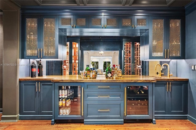 3916 Granada Blvd, Coral Gables, FL 33134 - bar featuring coffered ceiling, ornamental molding, wet bar, and beverage cooler