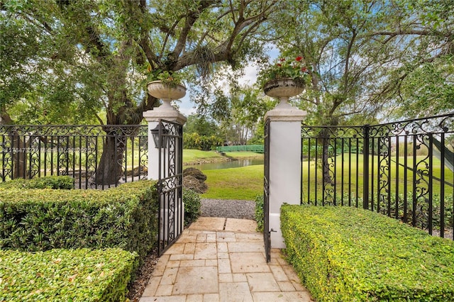 3916 Granada Blvd, Coral Gables, FL 33134 - view of gate featuring a lawn, a water view, and fence