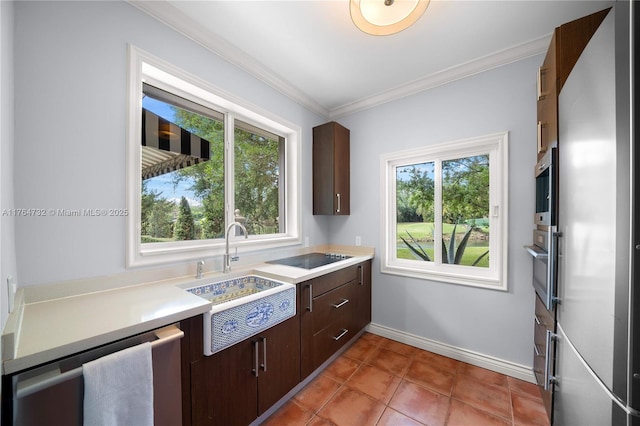 3916 Granada Blvd, Coral Gables, FL 33134 - kitchen featuring crown molding, light countertops, a sink, appliances with stainless steel finishes, and baseboards