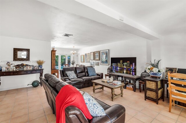 14841 Dade Pine Ave, Miami Lakes, FL 33014 - living room featuring a chandelier and light tile patterned flooring