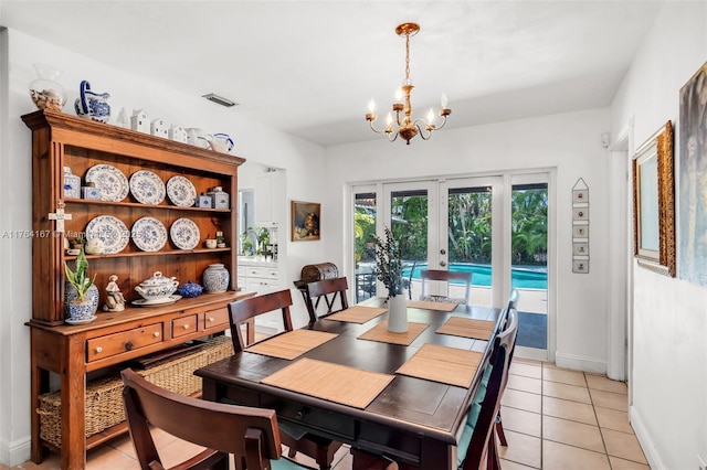 14841 Dade Pine Ave, Miami Lakes, FL 33014 - dining area featuring french doors, light tile patterned floors, a chandelier, and baseboards