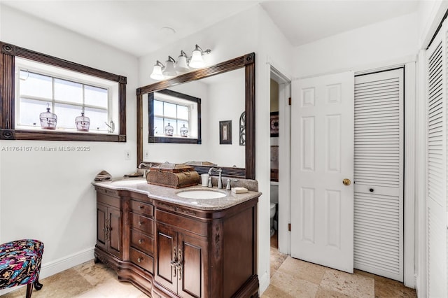 14841 Dade Pine Ave, Miami Lakes, FL 33014 - bathroom with vanity, toilet, a closet, and baseboards