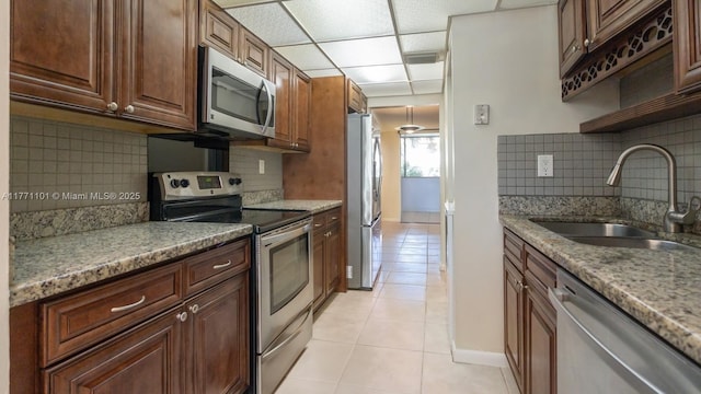 7401 NW 16th St Unit 207, Plantation, FL 33313 - kitchen with stainless steel appliances, a sink, light tile patterned floors, and backsplash