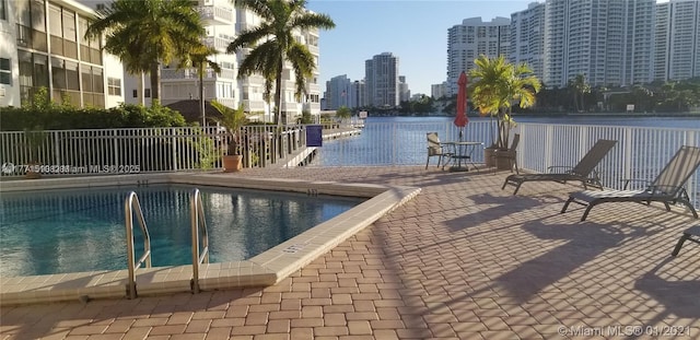 3161 S Ocean Dr Unit 708, Hallandale Beach, FL 33009 - pool featuring a city view, fence, a water view, and a patio