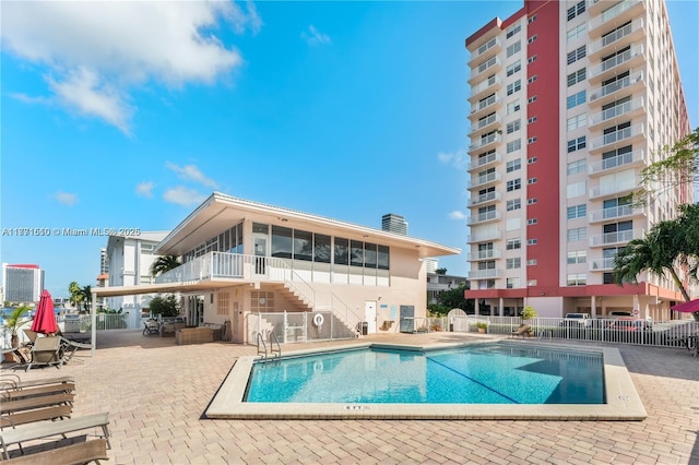 3161 S Ocean Dr Unit 708, Hallandale Beach, FL 33009 - community pool with a sunroom, stairway, fence, and a patio