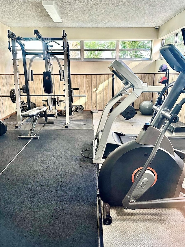 3161 S Ocean Dr Unit 708, Hallandale Beach, FL 33009 - gym with wainscoting, wood walls, and a textured ceiling