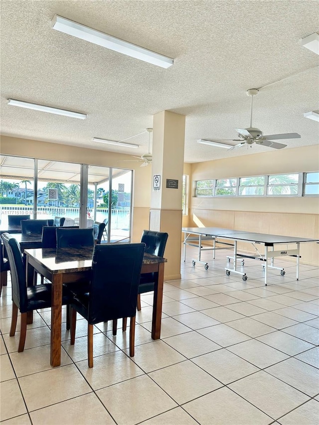 3161 S Ocean Dr Unit 708, Hallandale Beach, FL 33009 - dining space with a ceiling fan, light tile patterned floors, a textured ceiling, and a wealth of natural light