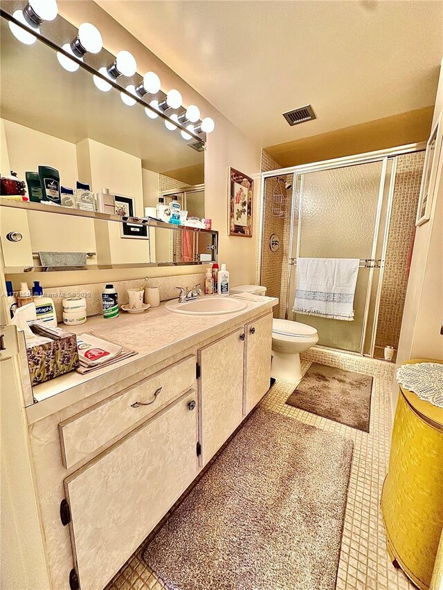 3161 S Ocean Dr Unit 708, Hallandale Beach, FL 33009 - bathroom featuring visible vents, a shower stall, toilet, vanity, and tile patterned flooring