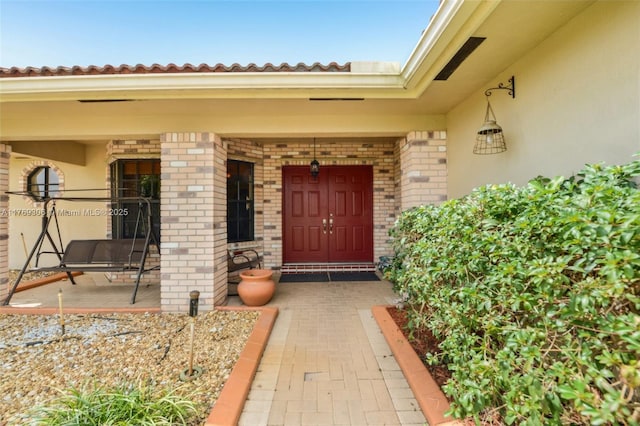 19460 NW 8th St, Pembroke Pines, FL 33029 - doorway to property with brick siding, covered porch, and stucco siding
