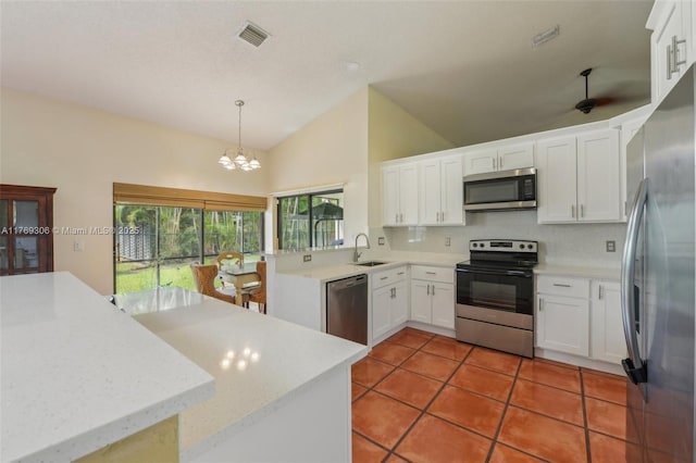 19460 NW 8th St, Pembroke Pines, FL 33029 - kitchen featuring appliances with stainless steel finishes, lofted ceiling, a sink, backsplash, and a chandelier