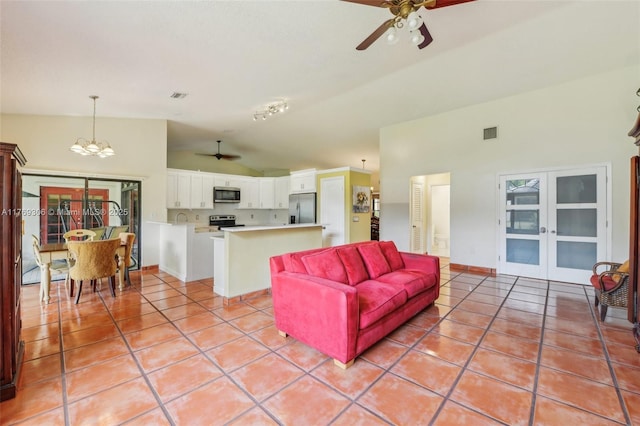 19460 NW 8th St, Pembroke Pines, FL 33029 - living room featuring a ceiling fan, french doors, light tile patterned floors, a chandelier, and high vaulted ceiling