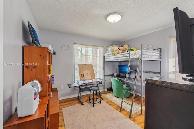 19460 NW 8th St, Pembroke Pines, FL 33029 - bedroom with a textured ceiling, light wood-style floors, an office area, and baseboards