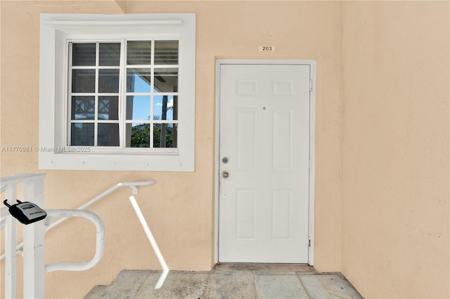 374 NE 26th Ave Unit 203, Homestead, FL 33033 - doorway to property featuring stucco siding