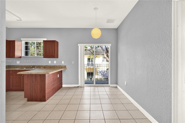 374 NE 26th Ave Unit 203, Homestead, FL 33033 - kitchen featuring a wealth of natural light, visible vents, a textured wall, and a peninsula
