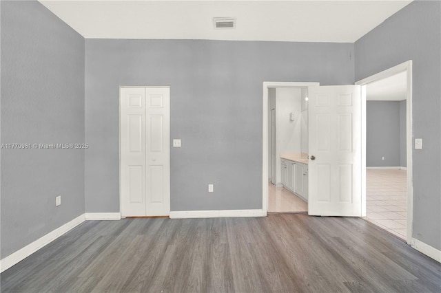 374 NE 26th Ave Unit 203, Homestead, FL 33033 - unfurnished room featuring baseboards, visible vents, and wood finished floors