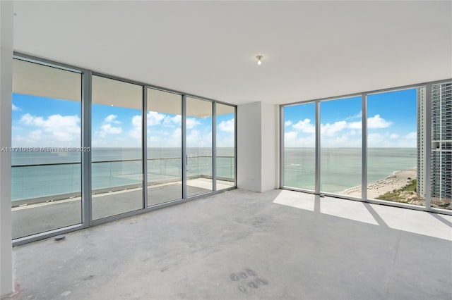 18501 Collins Ave Unit 1804, Sunny Isles Beach, FL 33160 - unfurnished room featuring a water view, a wall of windows, and unfinished concrete floors
