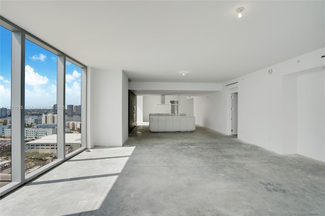 18501 Collins Ave Unit 1804, Sunny Isles Beach, FL 33160 - unfurnished living room featuring unfinished concrete flooring, floor to ceiling windows, and a view of city