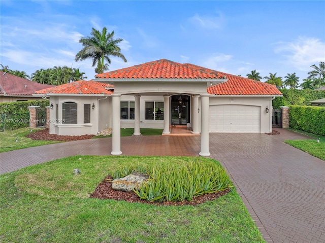 mediterranean / spanish home featuring a garage, driveway, a tile roof, and stucco siding