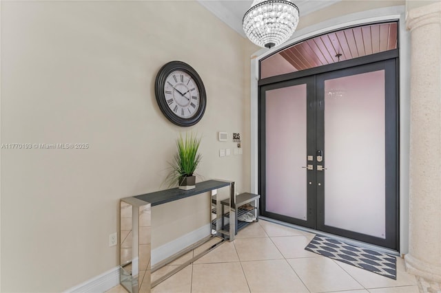 entryway with french doors, light tile patterned flooring, a chandelier, and baseboards