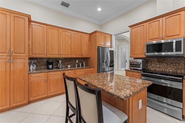 kitchen featuring stainless steel appliances, light tile patterned floors, tasteful backsplash, ornamental molding, and recessed lighting