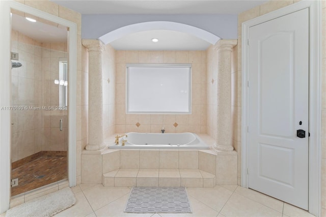 full bath with decorative columns, tile patterned floors, a bath, and a shower stall