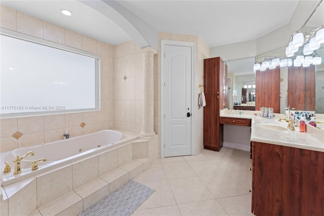 bathroom with tile patterned flooring, a tub with jets, vanity, and plenty of natural light