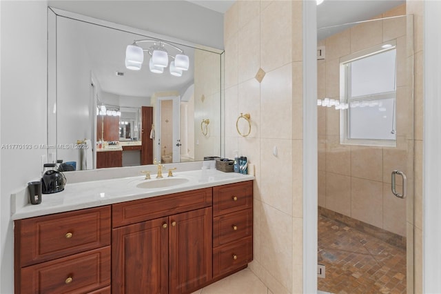 bathroom featuring a stall shower, vanity, tile patterned floors, tile walls, and plenty of natural light