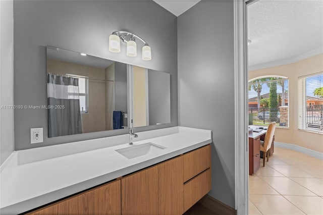 bathroom featuring vanity, tile patterned floors, baseboards, a shower with curtain, and a textured ceiling