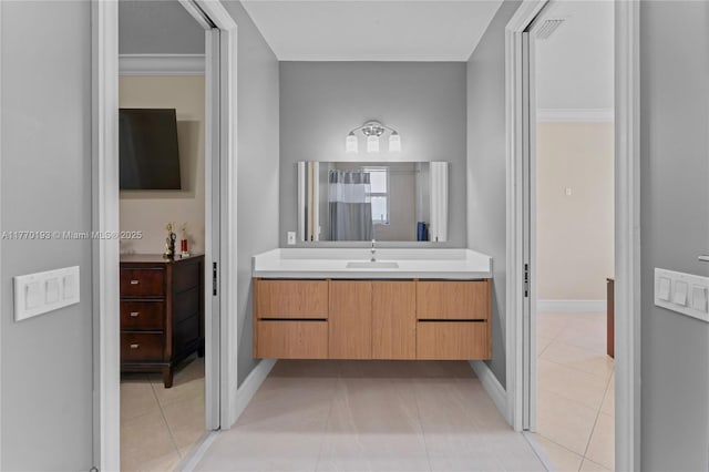 full bathroom with tile patterned floors, vanity, and baseboards