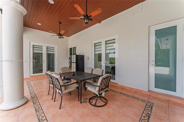 view of patio with french doors, outdoor dining area, and a ceiling fan
