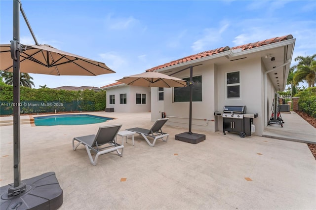view of pool featuring a patio area, area for grilling, and a fenced backyard