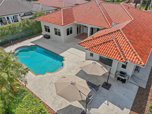 view of pool with a fenced backyard and a patio area