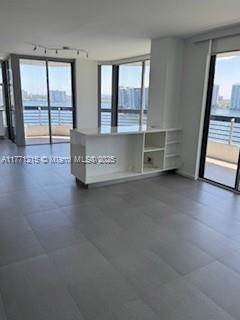 19101 NE Mystic Pointe Dr Unit 1601, Aventura, FL 33180 - empty room featuring rail lighting and plenty of natural light