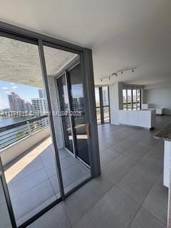 19101 NE Mystic Pointe Dr Unit 1601, Aventura, FL 33180 - entryway with track lighting, a wall of windows, a water view, a view of city, and dark tile patterned flooring