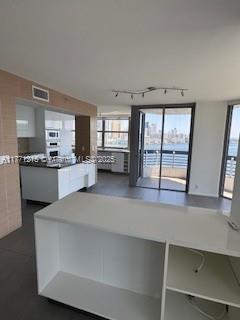 19101 NE Mystic Pointe Dr Unit 1601, Aventura, FL 33180 - kitchen with rail lighting and healthy amount of natural light