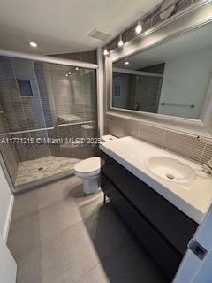 19101 NE Mystic Pointe Dr Unit 1601, Aventura, FL 33180 - bathroom with toilet, a stall shower, vanity, and tile patterned flooring