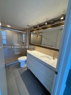 19101 NE Mystic Pointe Dr Unit 1601, Aventura, FL 33180 - bathroom featuring a shower stall, toilet, and double vanity