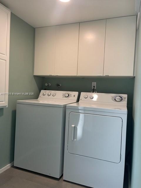 19101 NE Mystic Pointe Dr Unit 1601, Aventura, FL 33180 - clothes washing area featuring separate washer and dryer, cabinet space, and baseboards