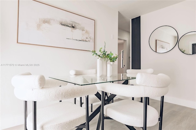 dining room featuring baseboards and wood finished floors